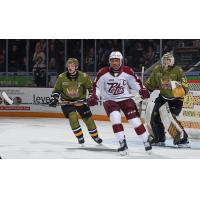 Peterborough Petes' Donovan McCoy and North Bay Battalion's Charlie Robertson and Paul Christopoulos on the ice