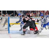 Wichita Thunder forward Jay Dickman (back) battles the Rapid City Rush