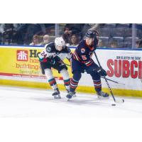 Kelowna Rockets centre Dylan Wightman (left) vs. the Kamloops Blazers