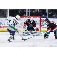 Seattle Thunderbirds' Sam Popowich battles Kelowna Rockets' Nathan Kam and Kayden Longley