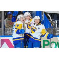 Saskatoon Blades' Brandon Lisowsky, Yegor Sidorov, and Trevor Wong celebrate win