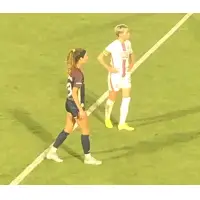 Megan Rapinoe of OL Reign (right) vs. the North Carolina Courage