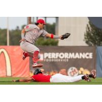 Fargo-Moorhead RedHawks slide under a Winnipeg Goldeyes fielder