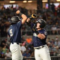 Elijah Dunham of the Somerset Patriots (right) celebrates a homer