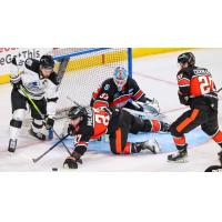 Wichita Thunder forward Dillon Boucher (far left) eyes a loose puck against the Kansas City Mavericks