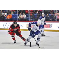 Syracuse Crunch defenseman Derrick Pouliot (right) vs. the Utica Comets