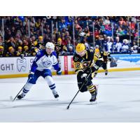 Syracuse Crunch defenseman Derrick Pouliot (left) vs. the Wilkes-Barre/Scranton Penguins