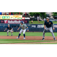 Nick Biddison of the Tulsa Oilers leads off first base