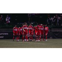 Chicago Fire FC breaks their huddle after a score against the New England Revolution