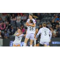 Racing Louisville FC celebrates a goal against Angel City